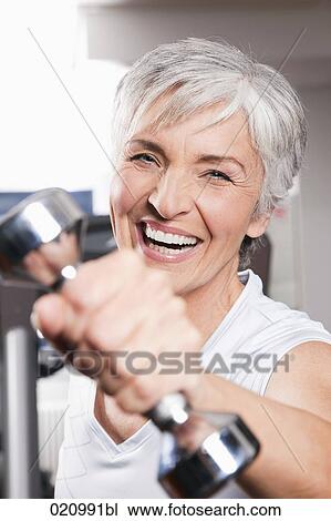 portrait of mature woman exercising with dumb bells View Large Photo Image Stock Image - portrait of mature woman exercising with dumb bells. Fotosearch