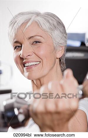 portrait of mature woman exercising with dumb bells View Large Photo Image Stock Image - portrait of mature woman exercising with dumb bells. Fotosearch