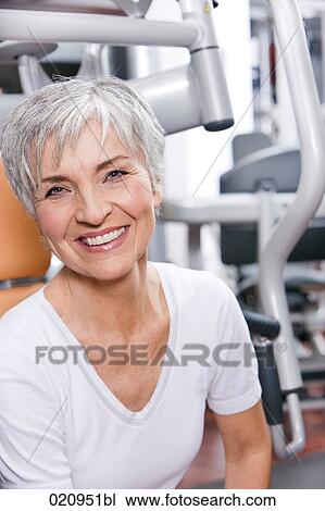 Stock Image - portrait of mature woman in gym. Fotosearch