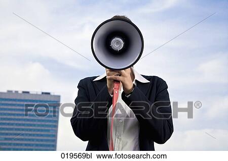 portrait of young businesswoman hidden behind megaphone View Large Photo Image Stock Image - portrait of young businesswoman hidden behind megaphone. Fotosearch