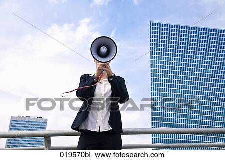 portrait of young businesswoman hidden behind megaphone View Large Photo Image Stock Image - portrait of young businesswoman hidden behind megaphone. Fotosearch