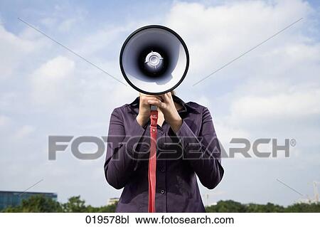 portrait of young businesswoman hidden behind megaphone View Large Photo Image Stock Image - portrait of young businesswoman hidden behind megaphone. Fotosearch