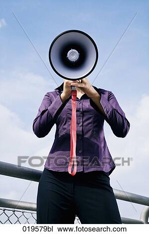 portrait of young businesswoman hidden behind megaphone View Large Photo Image Stock Image - portrait of young businesswoman hidden behind megaphone. Fotosearch