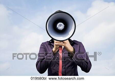 portrait of young businesswoman hidden behind megaphone View Large Photo Image Stock Image - portrait of young businesswoman hidden behind megaphone. Fotosearch