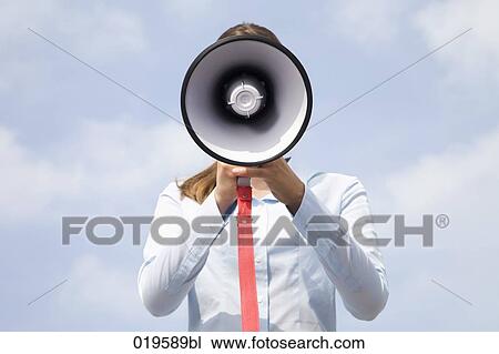 portrait of young businesswoman hidden behind megaphone View Large Photo Image Stock Image - portrait of young businesswoman hidden behind megaphone. Fotosearch