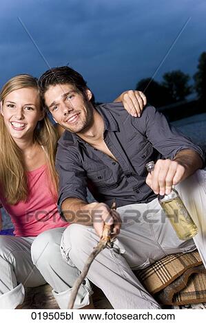 portrait of young couple at party on riverbank in summer View Large Photo Image Stock Image - portrait of young couple at party on riverbank in summer. Fotosearch