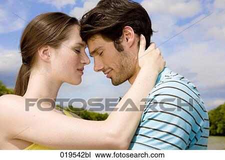 portrait of young couple in tender embrace outdoors View Large Photo Image Stock Image - portrait of young couple in tender embrace outdoors. Fotosearch