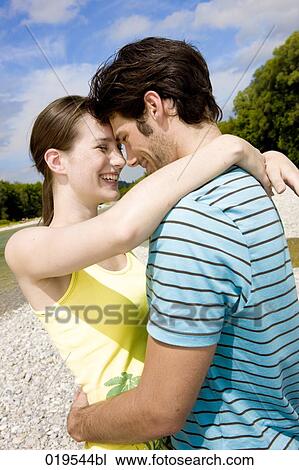 portrait of young couple in tender embrace outdoors View Large Photo Image Stock Image - portrait of young couple in tender embrace outdoors. Fotosearch