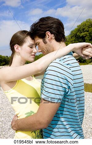 portrait of young couple in tender embrace outdoors View Large Photo Image Stock Image - portrait of young couple in tender embrace outdoors. Fotosearch