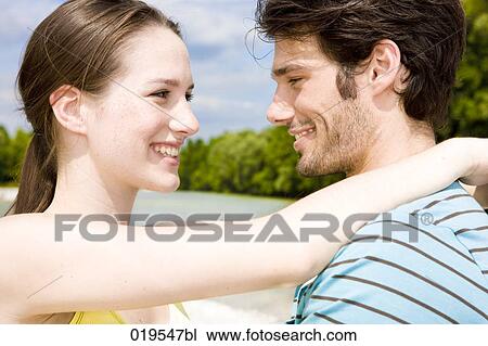 portrait of young couple in tender embrace outdoors View Large Photo Image Stock Image - portrait of young couple in tender embrace outdoors. Fotosearch