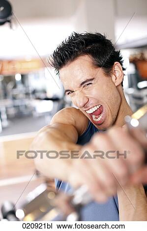 portrait of young man exercising with dumb bell View Large Photo Image Stock Image - portrait of young man exercising with dumb bell. Fotosearch