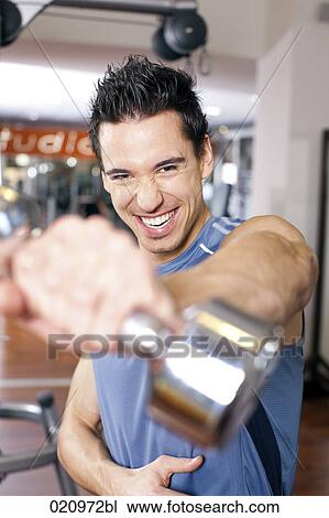 portrait of young man exercising with dumb bell View Large Photo Image Stock Image - portrait of young man exercising with dumb bell. Fotosearch
