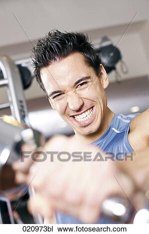 portrait of young man exercising with dumb bell View Large Photo Image Stock Image - portrait of young man exercising with dumb bell. Fotosearch