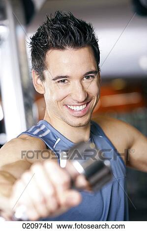 portrait of young man exercising with dumb bell View Large Photo Image Stock Image - portrait of young man exercising with dumb bell. Fotosearch