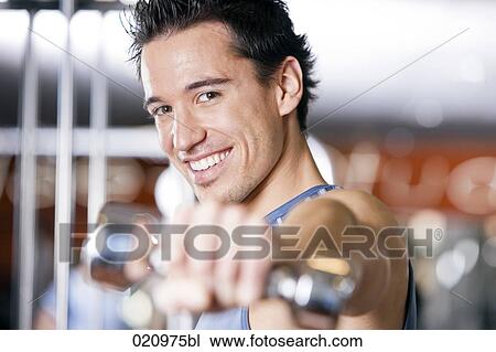 portrait of young man exercising with dumb bell View Large Photo Image Stock Image - portrait of young man exercising with dumb bell. Fotosearch