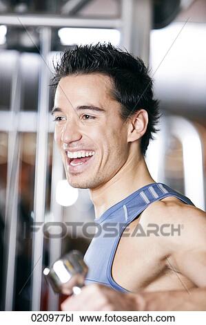 portrait of young man exercising with dumb bell View Large Photo Image Stock Image - portrait of young man exercising with dumb bell. Fotosearch
