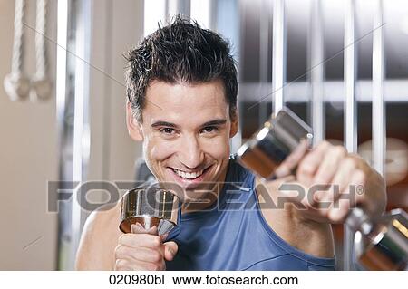 portrait of young man exercising with dumb bells View Large Photo Image Stock Image - portrait of young man exercising with dumb bells. Fotosearch