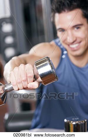 portrait of young man exercising with dumb bell View Large Photo Image Stock Image - portrait of young man exercising with dumb bell. Fotosearch