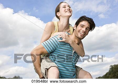 portrait of young man giving girlfriend piggyback ride View Large Photo Image Stock Image - portrait of young man giving girlfriend piggyback ride. Fotosearch