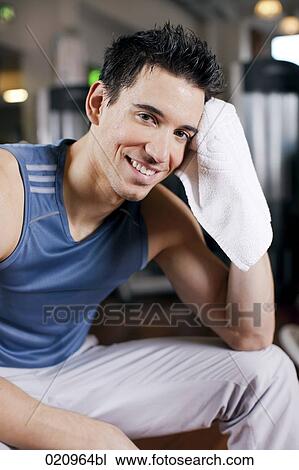 portrait of young man taking a rest in gym View Large Photo Image Stock Image - portrait of young man taking a rest in gym. Fotosearch