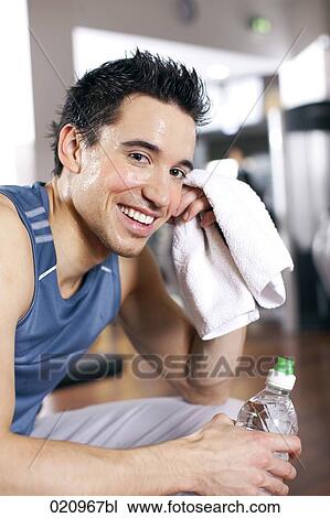 portrait of young man taking a rest in gym View Large Photo Image Stock Image - portrait of young man taking a rest in gym. Fotosearch