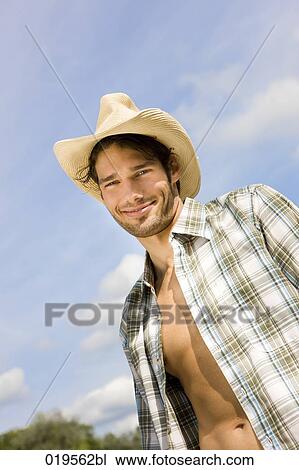 Stock Image - portrait of young man with open shirt outdoors. Fotosearch