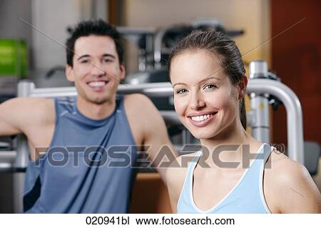 portrait of young woman and man in gym View Large Photo Image Stock Image - portrait of young woman and man in gym. Fotosearch