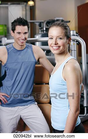 portrait of young woman and man in gym View Large Photo Image Stock Image - portrait of young woman and man in gym. Fotosearch