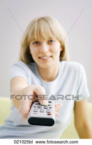 portrait of young woman holding remote control View Large Photo Image Stock Image - portrait of young woman holding remote control. Fotosearch