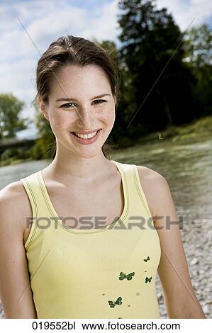 portrait of young woman in nature View Large Photo Image Stock Image - portrait of young woman in nature. Fotosearch