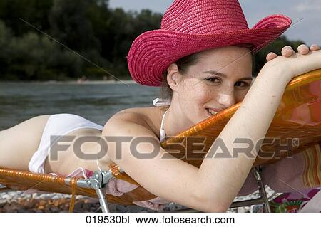 portrait of young woman taking sunbath by river View Large Photo Image Stock Image - portrait of young woman taking sunbath by river. Fotosearch