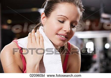 portrait of young woman with towel in gym View Large Photo Image Stock Image - portrait of young woman with towel in gym. Fotosearch