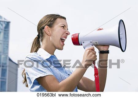 side view of young businesswoman shouting through megaphone View Large Photo Image Stock Image - side view of young businesswoman shouting through megaphone. Fotosearch