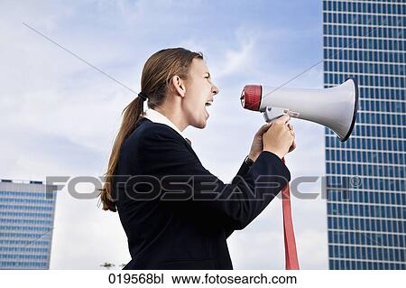 side view of young businesswoman shouting through megaphone View Large Photo Image Stock Image - side view of young businesswoman shouting through megaphone. Fotosearch