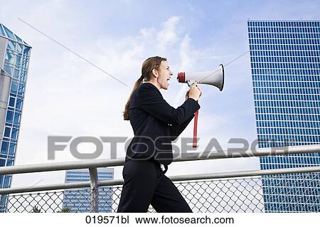side view of young businesswoman shouting through megaphone View Large Photo Image Stock Image - side view of young businesswoman shouting through megaphone. Fotosearch