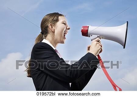 side view of young businesswoman shouting through megaphone View Large Photo Image Stock Image - side view of young businesswoman shouting through megaphone. Fotosearch