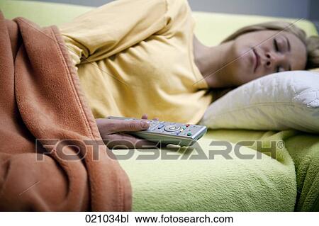 sleeping woman holding remote control View Large Photo Image Stock Image - sleeping woman holding remote control. Fotosearch