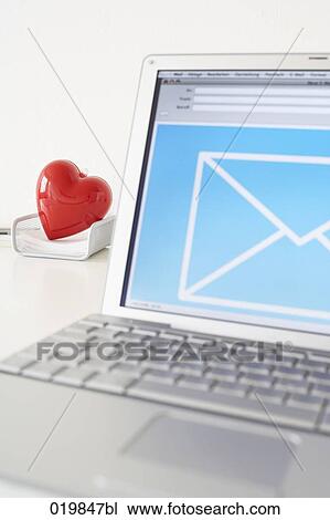still life of laptop computer with heart in tray in background View Large Photo Image Stock Image - still life of laptop computer with heart in tray in background. Fotosearch