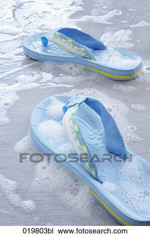 Stock Image - still life of pair of blue flip flops. Fotosearch