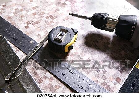 still life of ruler tape measure and cordless screwdriver View Large Photo Image Stock Image - still life of ruler tape measure and cordless screwdriver. Fotosearch