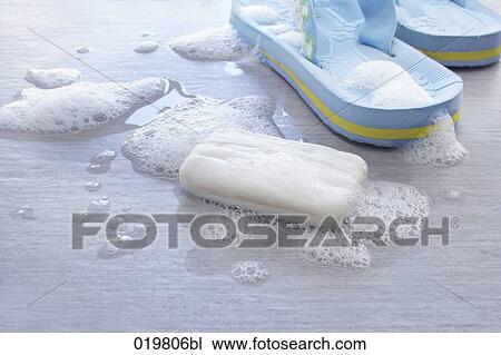 Stock Image - still life of soap and pair of flip flops. Fotosearch