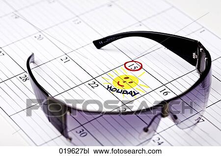 Stock Image - still life of sunglasses with holiday marked in calendar. Fotosearch
