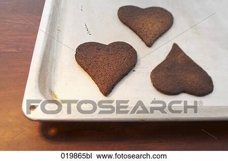 still life of three heart shaped cookies on tray View Large Photo Image Stock Image - still life of three heart shaped cookies on tray. Fotosearch