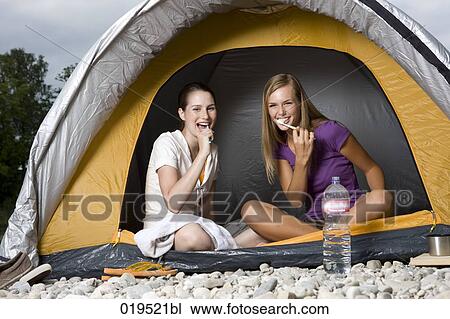 two young women sitting in tent brushing their teeth View Large Photo Image Stock Image - two young women sitting in tent brushing their teeth. Fotosearch