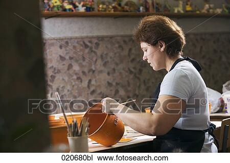 woman painting jar in workshop View Large Photo Image Stock Image - woman painting jar in workshop. Fotosearch