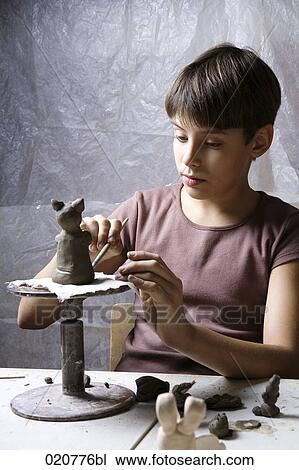 young boy forming little sculpture out of clay View Large Photo Image Stock Image - young boy forming little sculpture out of clay. Fotosearch