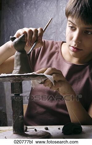 young boy forming little sculpture out of clay View Large Photo Image Stock Image - young boy forming little sculpture out of clay. Fotosearch
