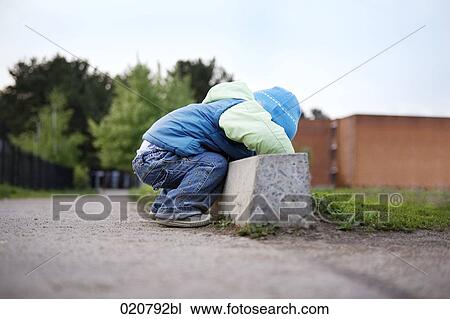 young boy playing in the street View Large Photo Image Stock Image - young boy playing in the street. Fotosearch