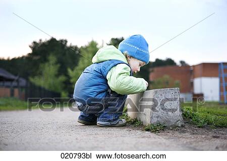 young boy playing in the street View Large Photo Image Stock Image - young boy playing in the street. Fotosearch