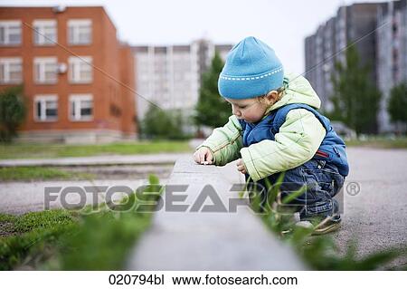 young boy playing in the street View Large Photo Image Stock Image - young boy playing in the street. Fotosearch